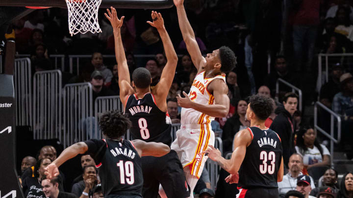 Mar 27, 2024; Atlanta, Georgia, USA; Atlanta Hawks guard Dejounte Murray (5) shoots layup shot against Portland Trail Blazers forward Kris Murray (8), Portland Trail Blazers guard Shaedon Sharpe (19), and Portland Trail Blazers forward Toumani Camara (33) during the second quarter at State Farm Arena. Mandatory Credit: Jordan Godfree-USA TODAY Sports