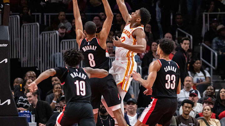 Mar 27, 2024; Atlanta, Georgia, USA; Atlanta Hawks guard Dejounte Murray (5) shoots layup shot against Portland Trail Blazers forward Kris Murray (8), Portland Trail Blazers guard Shaedon Sharpe (19), and Portland Trail Blazers forward Toumani Camara (33) during the second quarter at State Farm Arena. Mandatory Credit: Jordan Godfree-Imagn Images