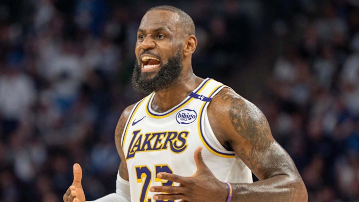 Los Angeles Lakers forward LeBron James talks with his coach during a stoppage against the Minnesota Timberwolves. Los Angeles Lakers forward LeBron James talks with his coach during a stoppage against the Minnesota Timberwolves.