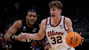 Illinois guard Kasparas Jakucionis (32) drives up to the basket as Xavier guard Dayvion McKnight (20) attempts to guard him during the second half of their first round NCAA men’ s basketball tournament game on Friday March 21, 2025 at Fiserv Forum in Milwaukee, Wis.