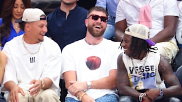 May 26, 2024; Dallas, Texas, USA; Kansas City Chiefs quarterback Patrick Mahomes II laughs with tight end Travis Kelce and wide receiver Marquis Hollywood Brown during the game between the Dallas Mavericks and Minnesota Timberwolves during game three of the western conference finals for the 2024 NBA playoffs at American Airlines Center. Mandatory Credit: Kevin Jairaj-Imagn Images