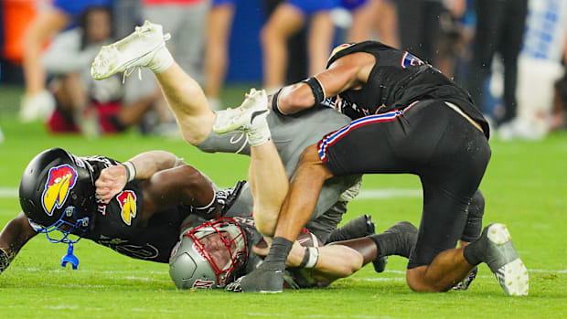 Sep 13, 2024; Kansas City, Kansas, USA; UNLV Rebels quarterback Matthew Sluka (3) is tackled by Kansas Jayhawks linebacker Tr