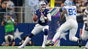 Dallas Cowboys quarterback Dak Prescott drops to pass with pressure from Detroit Lions defensive end Josh Paschal.