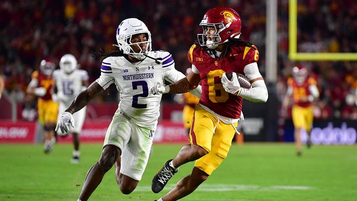 Nov 7, 2025; Los Angeles, California, USA; Southern California Trojans wide receiver Makai Lemon (6) runs the ball against Northwestern Wildcats cornerback Fred Davis II (2) during the second half at the Los Angeles Memorial Coliseum. Mandatory Credit: Gary A. Vasquez-Imagn Images