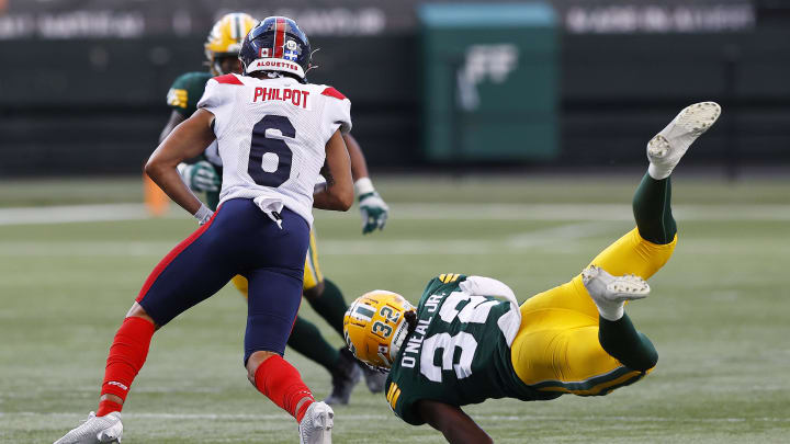 Jun 14, 2024; Edmonton, Alberta, CAN; Edmonton Elks defensive back Leon O'Neal Jr. (32) dives to tackle Montreal Alouettes wide receiver Tyson Philpot (6) during the second half at Commonwealth Stadium. Mandatory Credit: Perry Nelson-USA TODAY Sports