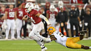 Nov 18, 2023; Stanford, California, USA; California Golden Bears defensive back Craig Woodson (2) dives in an attempt to tackle Stanford Cardinal quarterback Ashton Daniels (14) during the third quarter at Stanford Stadium. Mandatory Credit: Robert Edwards-Imagn Images