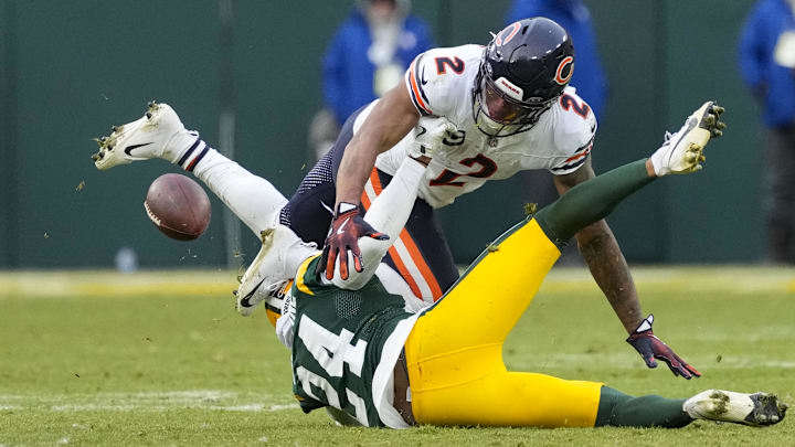 Green Bay Packers cornerback Carrington Valentine (24) forces Chicago Bears wide receiver DJ Moore (2) to fumble the football during the fourth quarter on Sunday. Green Bay Packers cornerback Carrington Valentine (24) forces Chicago Bears wide receiver DJ Moore (2) to fumble the football during the fourth quarter on Sunday.