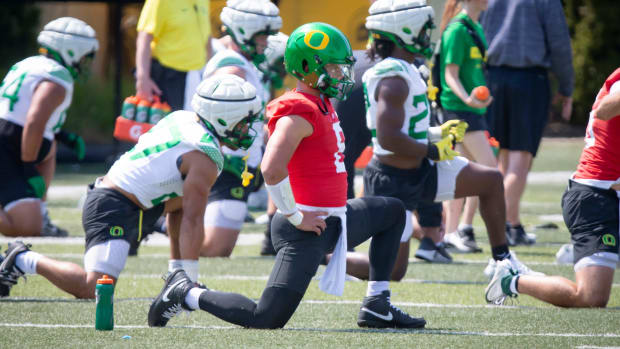 Oregon quarterback Dillon Gabriel stretches during practice with the Oregon Ducks 