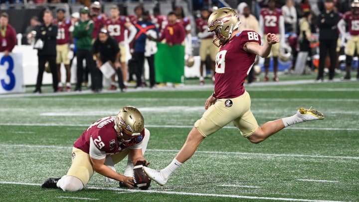 Dec 2, 2023; Charlotte, NC, USA; Florida State Seminoles place kicker Ryan Fitzgerald (88) kicks the ball as punter Alex Mastromanno (29) holds during the second quarter against the Louisville Cardinals at Bank of America Stadium. Mandatory Credit: Bob Donnan-USA TODAY Sports