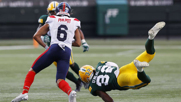 Jun 14, 2024; Edmonton, Alberta, CAN; Edmonton Elks defensive back Leon O'Neal Jr. (32) dives to tackle Montreal Alouettes wide receiver Tyson Philpot (6) during the second half at Commonwealth Stadium. Mandatory Credit: Perry Nelson-USA TODAY Sports