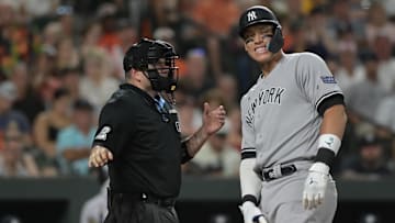 Jul 29, 2023; Baltimore, Maryland, USA;  Home plate umpire Dan Bellino (2) speaks with New York Yankees right fielder Aaron Judge (99) after a seventh inning at bat against the Baltimore Orioles at Oriole Park at Camden Yards. Mandatory Credit: Tommy Gilligan-Imagn Images