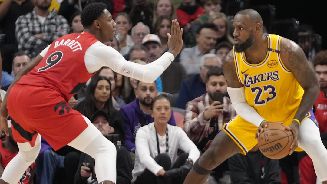 Toronto Raptors guard RJ Barrett (9) defends against Los Angeles Lakers forward LeBron James (23) during the second half at Scotiabank Arena. Mandatory Credit: John E. Sokolowski-Imagn Images