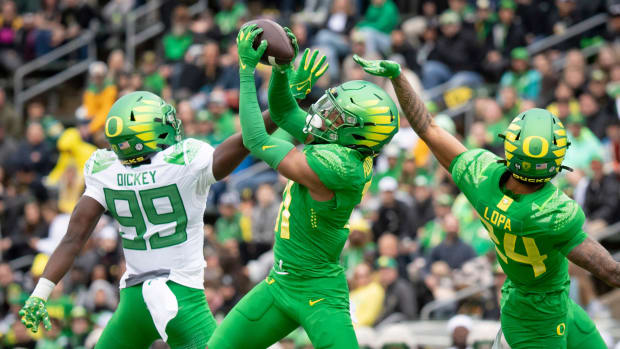 Oregon Green Team defensive back Dakoda Fields intercepts a pass indended for wide receiver Jurrion Dickey