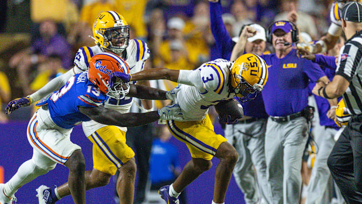 Sep 13, 2025; Baton Rouge, Louisiana, USA;  Florida Gators running back Jadan Baugh (13) pushes LSU Tigers cornerback DJ Pickett (3) out of bounds after an interception during the second half at Tiger Stadium. Mandatory Credit: Stephen Lew-Imagn Images