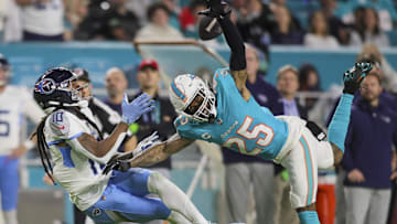 Dec 11, 2023; Miami Gardens, Florida, USA; Tennessee Titans wide receiver DeAndre Hopkins (10) catches the football against Miami Dolphins cornerback Xavien Howard (25) during the second quarter at Hard Rock Stadium. 
