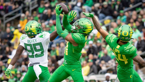 Oregon Green Team defensive back Dakoda Fields intercepts a pass indended for wide receiver Jurrion Dickey 