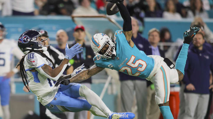 Dec 11, 2023; Miami Gardens, Florida, USA; Tennessee Titans wide receiver DeAndre Hopkins (10) catches the football against Miami Dolphins cornerback Xavien Howard (25) during the second quarter at Hard Rock Stadium. Mandatory Credit: Sam Navarro-USA TODAY Sports