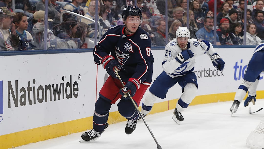 Oct 18, 2025; Columbus, Ohio, USA; Columbus Blue Jackets defenseman Zach Werenski (8) controls the puck defended by Tampa Bay Lightning center Brayden Point (21) during the third period at Nationwide Arena. Mandatory Credit: Russell LaBounty-Imagn Images