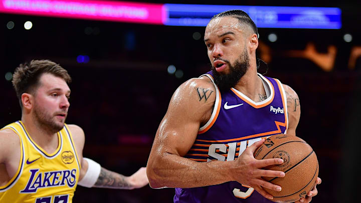 Phoenix Suns forward Dillon Brooks moves the ball against Los Angeles Lakers guard Luka Doncic during the first half at Crypto.com Arena.