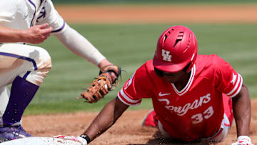 Former Cougars outfielder Tre Jones slides back into first base on a pickoff attempt. 