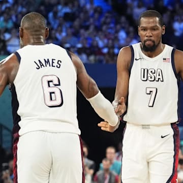 Aug 8, 2024; Paris, France; United States guard LeBron James (6) celebrates with guard Kevin Durant (7) during the first half in a men's basketball semifinal game during the Paris 2024 Olympic Summer Games at Accor Arena. Mandatory Credit: Rob Schumacher-Imagn Images