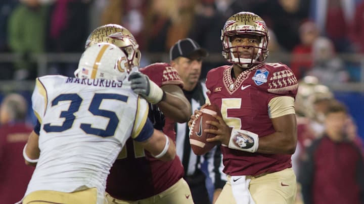 Dec 6, 2014; Charlotte, NC, USA; Florida State Seminoles quarterback Jameis Winston (5) looks to pass the ball during the third quarter against the Georgia Tech Yellow Jackets at Bank of America Stadium. FSU defeated Georgia Tech 37-35. Mandatory Credit: Jeremy Brevard-Imagn Images