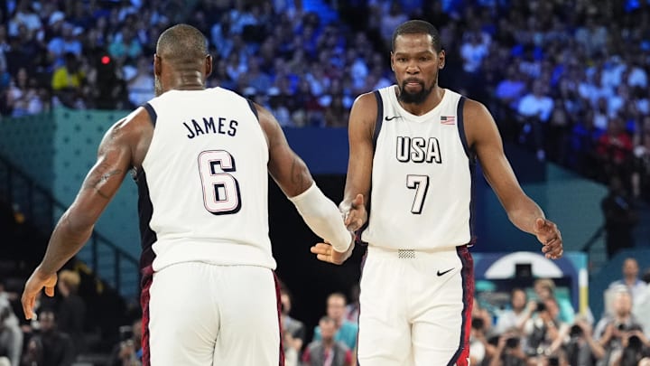 Aug 8, 2024; Paris, France; United States guard LeBron James (6) celebrates with guard Kevin Durant (7) during the first half in a men's basketball semifinal game during the Paris 2024 Olympic Summer Games at Accor Arena. Mandatory Credit: Rob Schumacher-Imagn Images