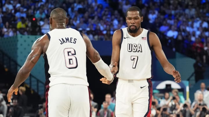 Aug 8, 2024; Paris, France; United States guard LeBron James (6) celebrates with guard Kevin Durant (7) during the first half in a men's basketball semifinal game during the Paris 2024 Olympic Summer Games at Accor Arena.