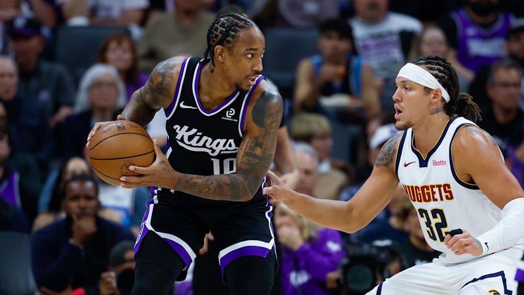 Nov 11, 2025; Sacramento, California, USA; Sacramento Kings guard DeMar DeRozan (10) controls the ball against Denver Nuggets forward Aaron Gordon (32) during the first quarter at Golden 1 Center. Mandatory Credit: Sergio Estrada-Imagn Images