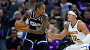 Nov 11, 2025; Sacramento, California, USA; Sacramento Kings guard DeMar DeRozan (10) controls the ball against Denver Nuggets forward Aaron Gordon (32) during the first quarter at Golden 1 Center. Mandatory Credit: Sergio Estrada-Imagn Images