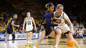 Iowa’s Kate Martin (20) drives to the basket as West Virginia’s Kyah Watson (32) defends in a NCAA Tournament round of 32 game Monday, March 25, 2024 at Carver-Hawkeye Arena.