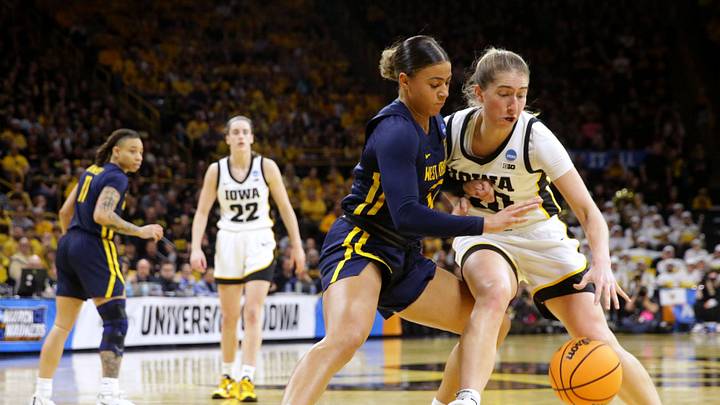 Iowa’s Kate Martin (20) drives to the basket as West Virginia’s Kyah Watson (32) defends in a NCAA Tournament round of 32 game Monday, March 25, 2024 at Carver-Hawkeye Arena.