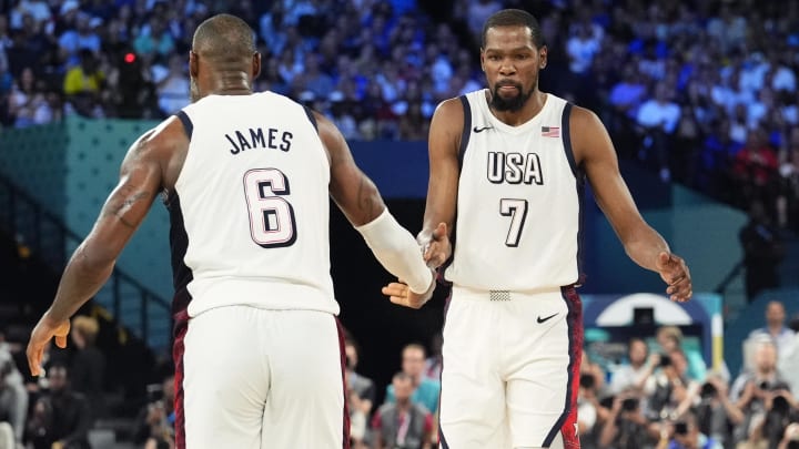 United States guard LeBron James (6) celebrates with guard Kevin Durant (7) during the first half in a men's basketball semifinal game during the Paris 2024 Olympic Summer Games at Accor Arena. Mandatory Credit: