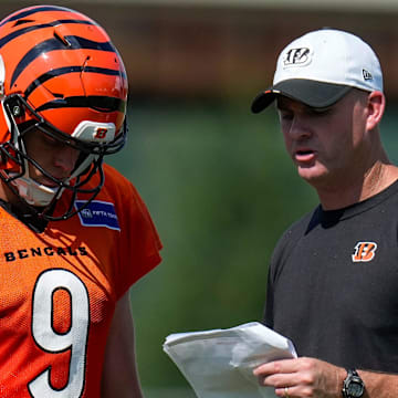 Cincinnati Bengals quarterback Joe Burrow (9) talks with head coach Zac Taylor during a preseason training camp practice in downtown Cincinnati on Wednesday, July 30, 2025.