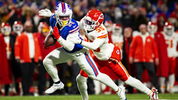 Jan 21, 2024; Orchard Park, New York, USA; Buffalo Bills running back Ty Johnson (26) rushes the ball past Kansas City Chiefs cornerback Jaylen Watson (35) during the second half for the 2024 AFC divisional round game at Highmark Stadium. Mandatory Credit: Mark J. Rebilas-Imagn Images