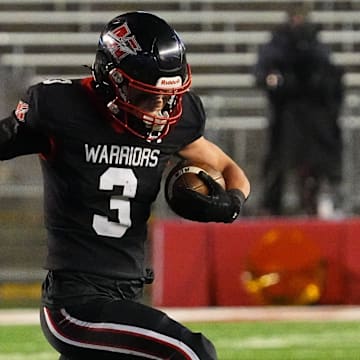 Muskego running back Jackson Niemiec (3) breaks a tackle during the WIAA Division 1 state championship football game at Camp Randall Stadium in Madison on Friday, Nov. 22, 2024.