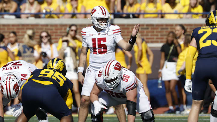 Oct 4, 2025; Ann Arbor, Michigan, USA;  Wisconsin Badgers quarterback Hunter Simmons (15) gets set to run a play in the first half against the Michigan Wolverines at Michigan Stadium.