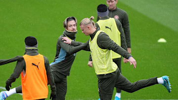 Jack Grealish (second left) and Erling Haaland (centre) warm up 