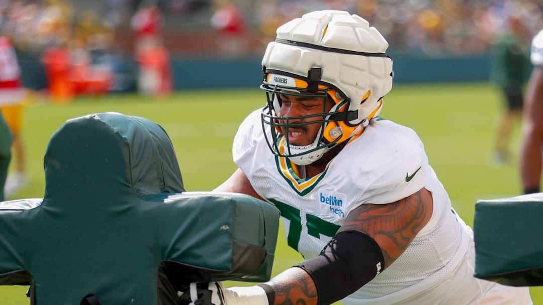 Green Bay Packers offensive lineman Jordan Morgan (77) runs through a drill during the 11th practice of training camp on Tuesday, August 6, 2024, at Ray Nitschke Field in Ashwaubenon, Wis. 