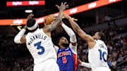 Mar 30, 2025; Minneapolis, Minnesota, USA; Detroit Pistons guard Malik Beasley (5) shoots the ball as Minnesota Timberwolves forward Jaden McDaniels (3) and guard Mike Conley (10) defend during the first quarter at Target Center. Mandatory Credit: Matt Krohn-Imagn Images