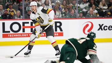 Mar 25, 2025; Saint Paul, Minnesota, USA; Vegas Golden Knights center Jack Eichel (9) skates with the puck as Minnesota Wild defenseman Zach Bogosian (24) defends during the third period at Xcel Energy Center. Mandatory Credit: Matt Krohn-Imagn Images