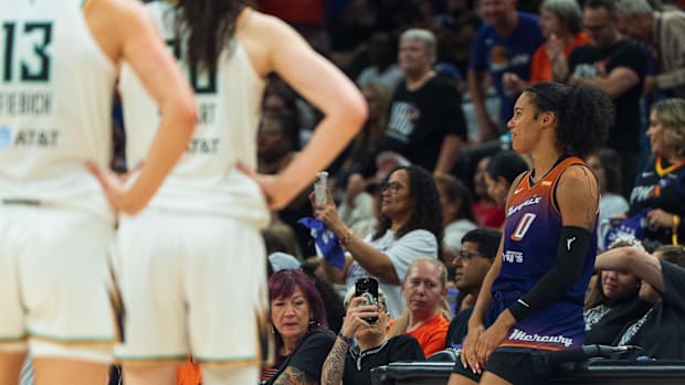 A photo of Satou Sabally sitting at the scorers tabl