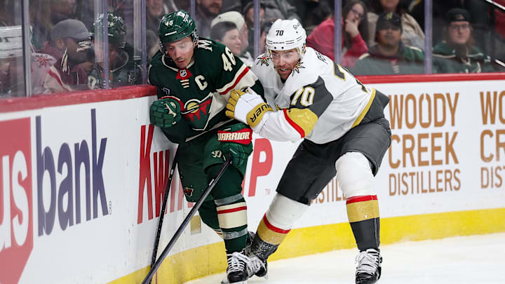 Mar 25, 2025; Saint Paul, Minnesota, USA; Minnesota Wild defenseman Jared Spurgeon (46) and Vegas Golden Knights left wing Tanner Pearson (70) compete for the puck during the third period at Xcel Energy Center. Mandatory Credit: Matt Krohn-Imagn Images