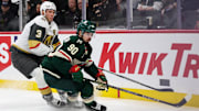Mar 25, 2025; Saint Paul, Minnesota, USA; Minnesota Wild left wing Marcus Johansson (90) and Vegas Golden Knights defenseman Brayden McNabb (3) compete for the puck during the second period at Xcel Energy Center. Mandatory Credit: Matt Krohn-Imagn Images