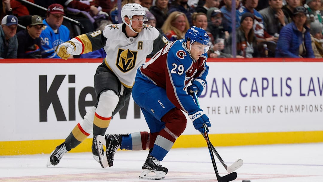 Nov 27, 2024; Denver, Colorado, USA; Colorado Avalanche center Nathan MacKinnon (29) controls the puck ahead of Vegas Golden Knights center Jack Eichel (9) in the third period at Ball Arena. Mandatory Credit: Isaiah J. Downing-Imagn Images