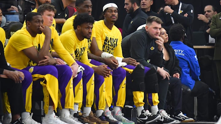 Luka Doncic sits on the Lakers' bench during a game. Luka Doncic sits on the Lakers' bench during a game.