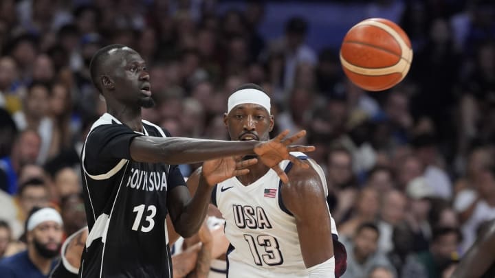 Jul 31, 2024; Villeneuve-d'Ascq, France; South Sudan power forward Majok Deng (13) passes against United States center Bam Adebayo (13) in the third quarter during the Paris 2024 Olympic Summer Games at Stade Pierre-Mauroy. Mandatory Credit: John David Mercer-USA TODAY Sports