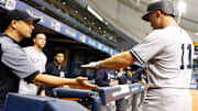 New York Yankees center fielder Brett Gardner is congratulated by New York Yankees manager Aaron Boone.