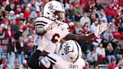 Mississippi State Bulldogs running back Davon Booth (6) celebrates with offensive lineman Jayvin Q. James (77) after scoring a touchdown in the first quarter against the Arkansas Razorbacks at Donald W. Reynolds Razorback Stadium.