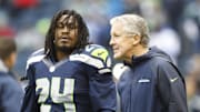 Former Seattle Seahawks head coach Pete Carroll talks with running back Marshawn Lynch during a pregame in 2013.